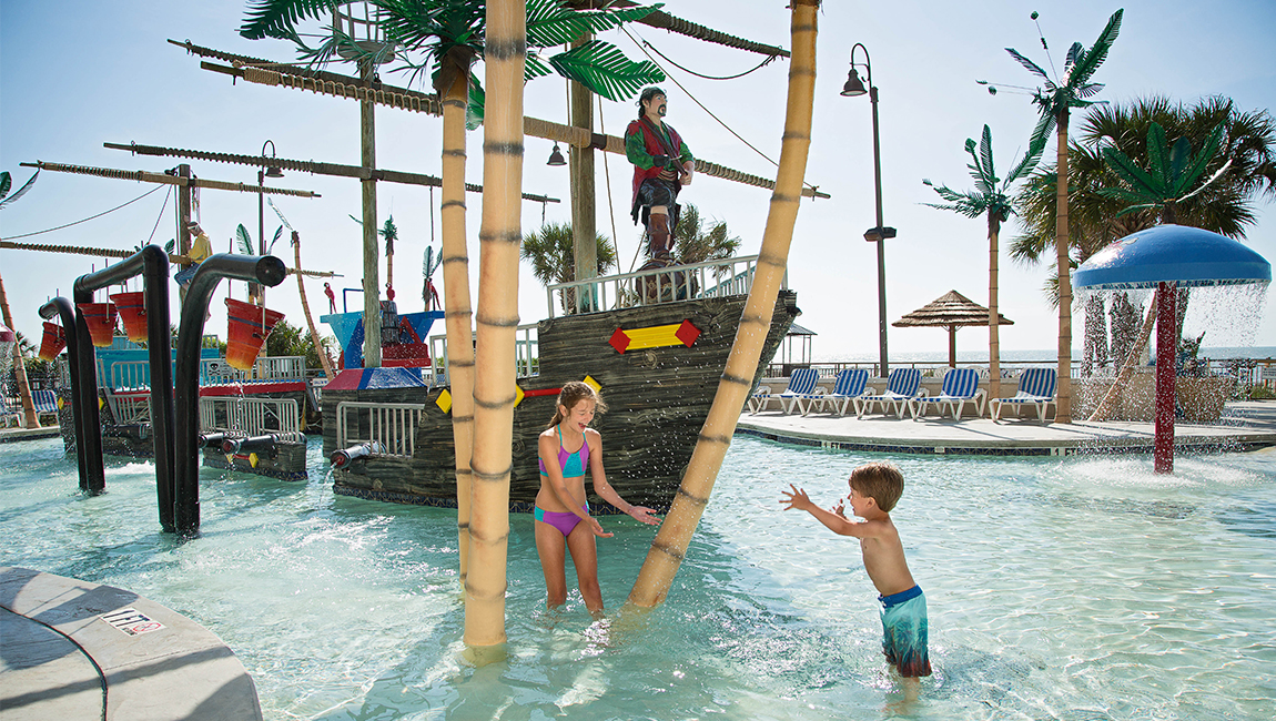 A family-friendly pool area with a pirate ship water feature.